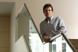 Michale Fee leans on a stair rail.
