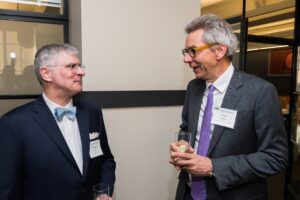 Photo of Thomas Frank and Peter Fisher talking at a party