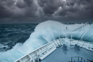 A large ocean wave hitting the front of a ship