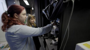Kendyll Burnell and Elly Nedivi examining a machine together