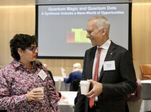 Dean Nergis Mavalvala and Moungi Bawendi talk and hold coffee cups at breakfast